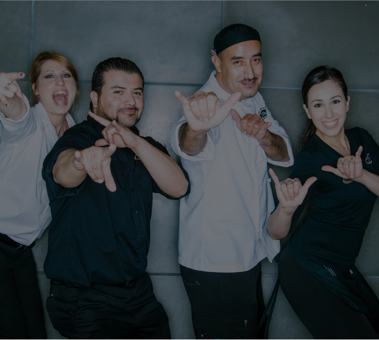 Four Darden restaurant team members smiling to camera