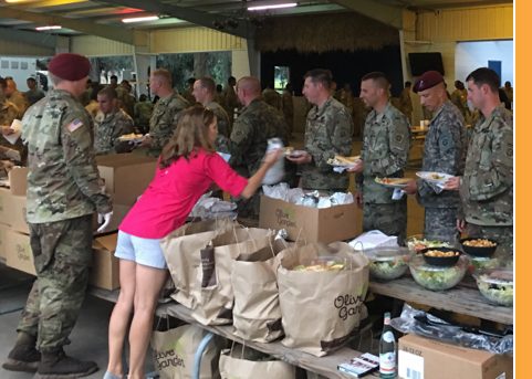 Restaurant team members serving meals to service personnel